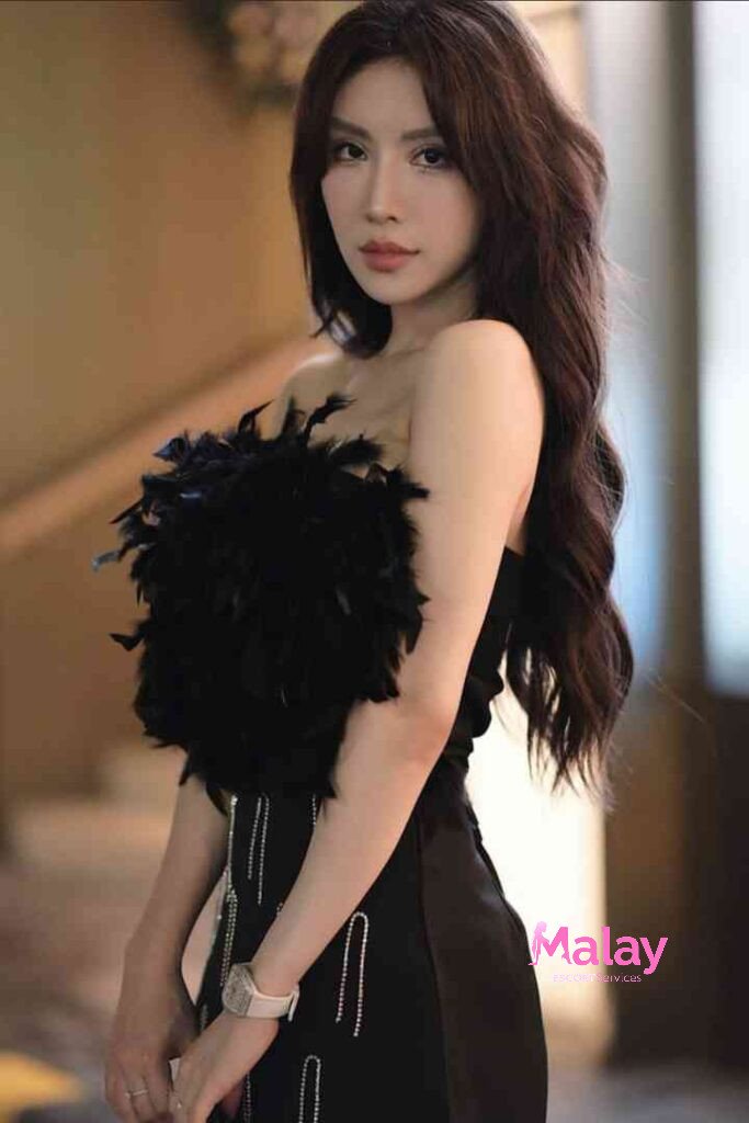 Malay Escort Service Elegant woman in a black strapless dress with feather detail KL Escort Girl Malay Escort KL Real KL Escorts Ready for You Malay Escort Service Elegant woman in a black strapless dress with feather detail KL Escort Girl