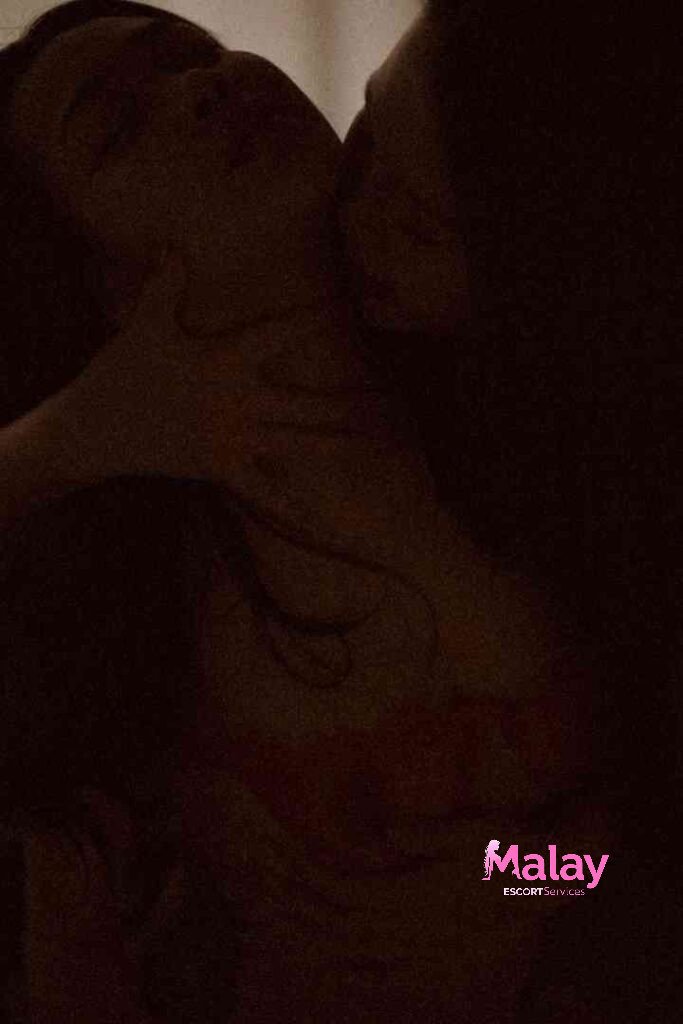 Malay Escort Service Couple embracing intimately in dim lighting showing a tattoo on the chest KL Escort Girl Malay Escort KL Real KL Escorts Ready for You Malay Escort Service Couple embracing intimately in dim lighting showing a tattoo on the chest KL Escort Girl