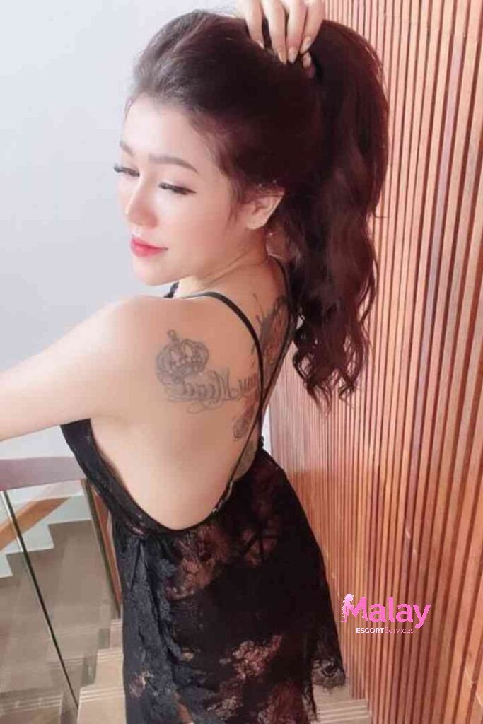 Malay Escort Service Woman with a tattoo on her back wearing a black lace dress KL Escort Girl Malay Escort KL Real KL Escorts Ready for You Malay Escort Service Woman with a tattoo on her back wearing a black lace dress KL Escort Girl