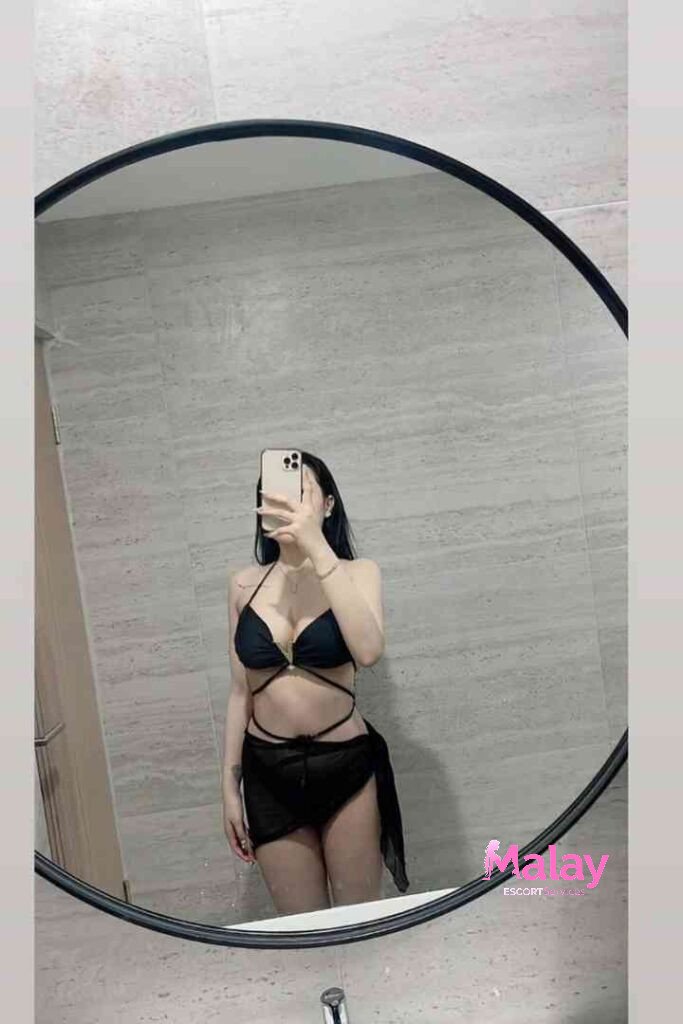 Malay Escort Service Woman in black bikini and sheer skirt posing in bathroom mirror KL Escort Girl Malay Escort KL Real KL Escorts Ready for You Malay Escort Service Woman in black bikini and sheer skirt posing in bathroom mirror KL Escort Girl