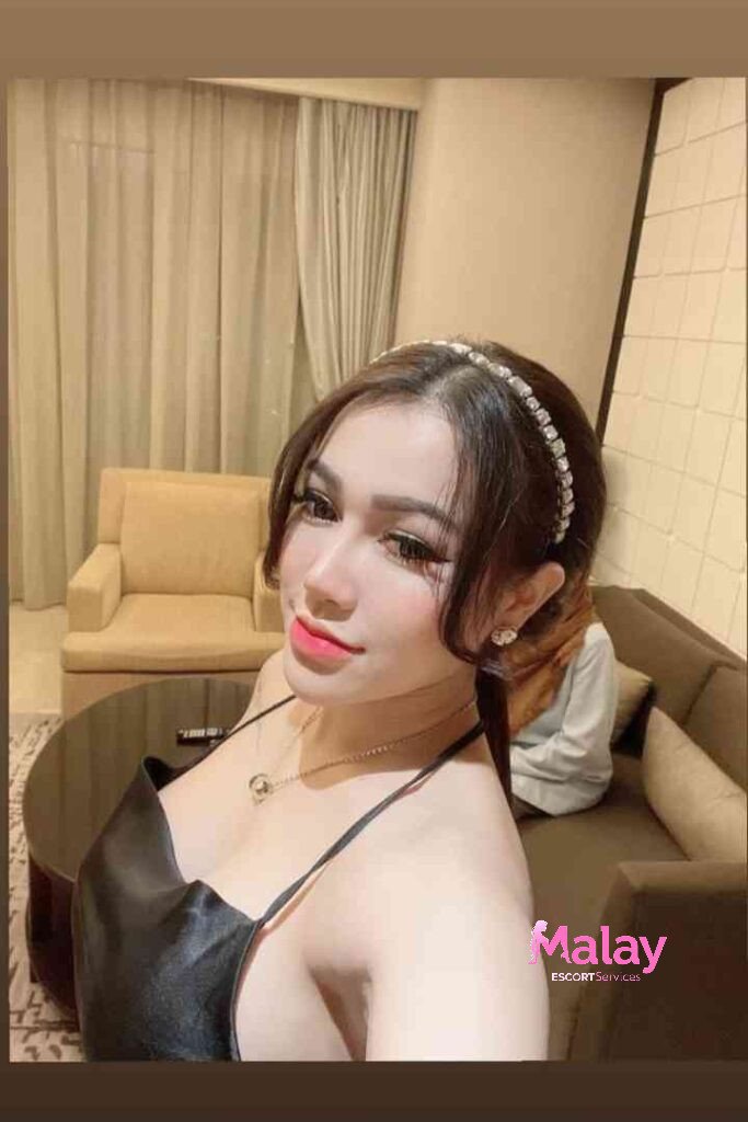 Malay Escort Service Woman in black dress with headband and necklace posing indoors KL Escort Girl Malay Escort KL Real KL Escorts Ready for You Malay Escort Service Woman in black dress with headband and necklace posing indoors KL Escort Girl
