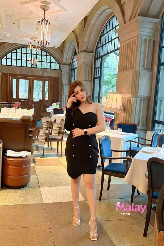 Malay Escort Service Woman in black one shoulder dress posing in a restaurant KL Escort Girl