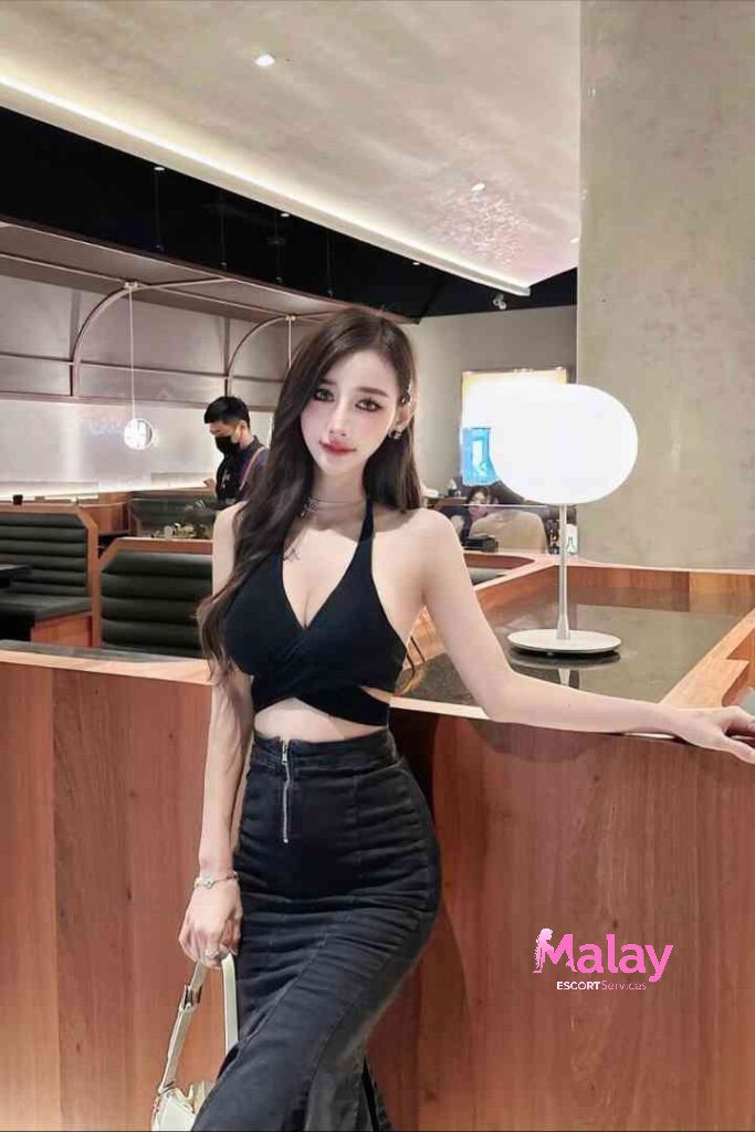 Malay Escort Service Stylish woman in black halter top and highwaisted jeans posing in a modern restaurant KL Escort Girl Malay Escort KL Real KL Escorts Ready for You Malay Escort Service Stylish woman in black halter top and high waisted jeans posing in a modern restaurant KL Escort Girl