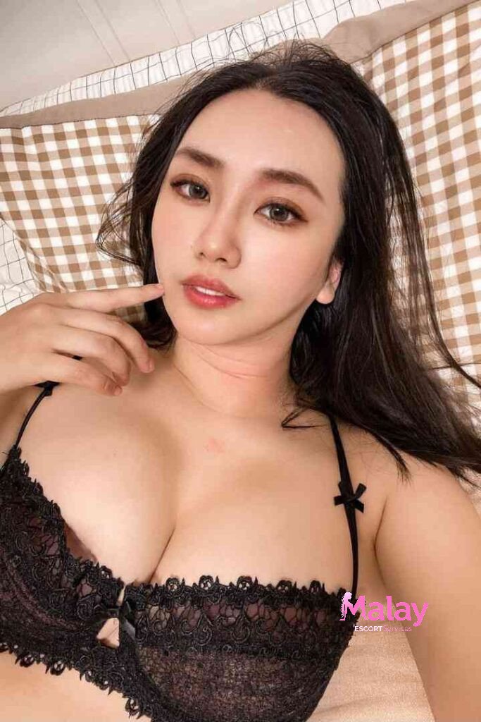 Malay Escort Service Woman in black lace bra lying on a checkered bedspread looking at the camera KL Escort Girl Malay Escort KL Real KL Escorts Ready for You Malay Escort Service Woman in black lace bra lying on a checkered bedspread looking at the camera KL Escort Girl