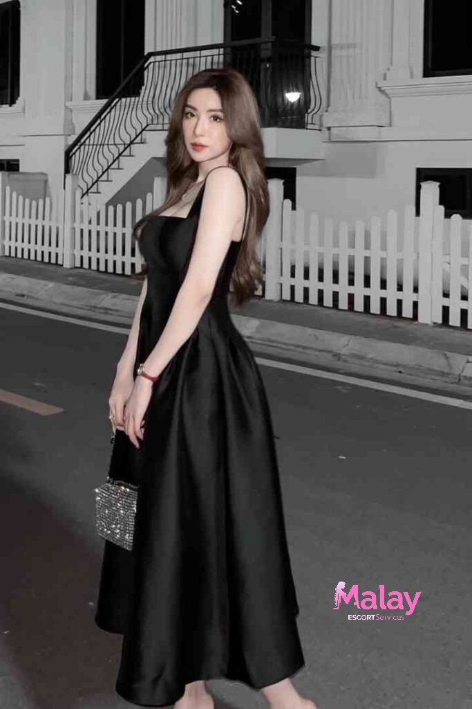 Malay Escort Service Elegant woman in a black satin midi dress and sparkling clutch KL Escort Girl Malay Escort KL Real KL Escorts Ready for You Malay Escort Service Elegant woman in a black satin midi dress and sparkling clutch KL Escort Girl
