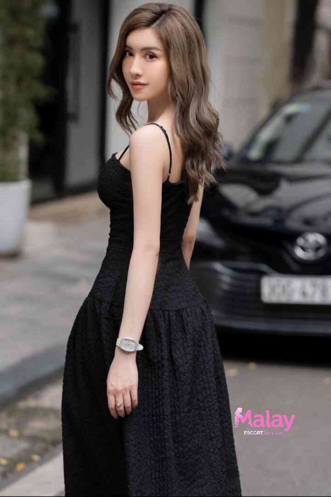 Malay Escort Service Woman in black textured dress with spaghetti straps and a watch KL Escort Girl Malay Escort KL Real KL Escorts Ready for You Malay Escort Service Woman in black textured dress with spaghetti straps and a watch KL Escort Girl