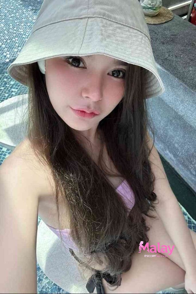 Malay Escort Service Young woman in a bucket hat and bikini taking a selfie by a pool KL Escort Girl Malay Escort KL Real KL Escorts Ready for You Malay Escort Service Young woman in a bucket hat and bikini taking a selfie by a pool KL Escort Girl