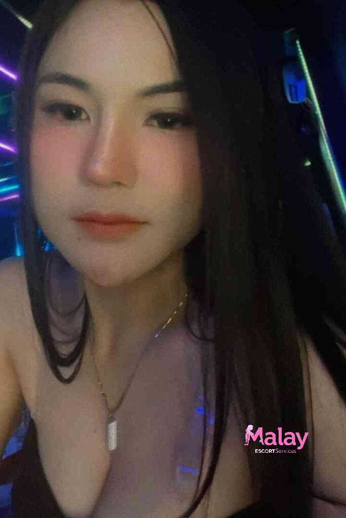 Malay Escort Service Young woman with dark hair and light makeup wearing a necklace KL Escort Girl