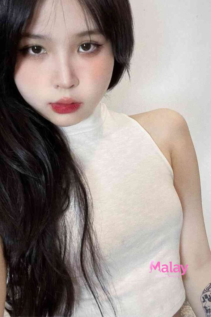 Malay Escort Service Young woman with long dark hair and red lipstick wears a white halter top KL Escort Girl Malay Escort KL Real KL Escorts Ready for You Malay Escort Service Young woman with long dark hair and red lipstick wears a white halter top KL Escort Girl