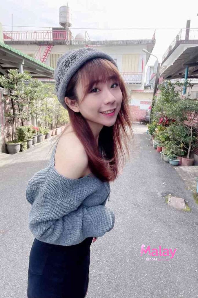 Malay Escort Service Young woman in a grey beanie and offtheshoulder sweater smiles at the camera outdoors KL Escort Girl Malay Escort KL Real KL Escorts Ready for You Malay Escort Service Young woman in a grey beanie and off the shoulder sweater smiles at the camera outdoors KL Escort Girl