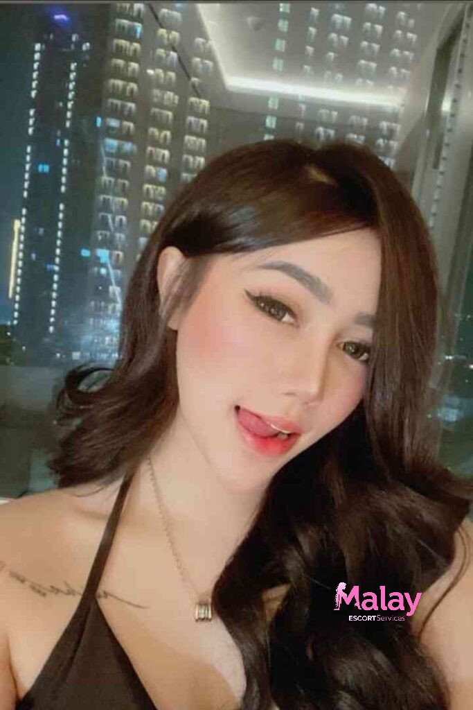 Malay Escort Service Young woman with long brown hair makeup and a black top sticks her tongue out KL Escort Girl Malay Escort KL Real KL Escorts Ready for You Malay Escort Service Young woman with long brown hair makeup and a black top sticks her tongue out KL Escort Girl