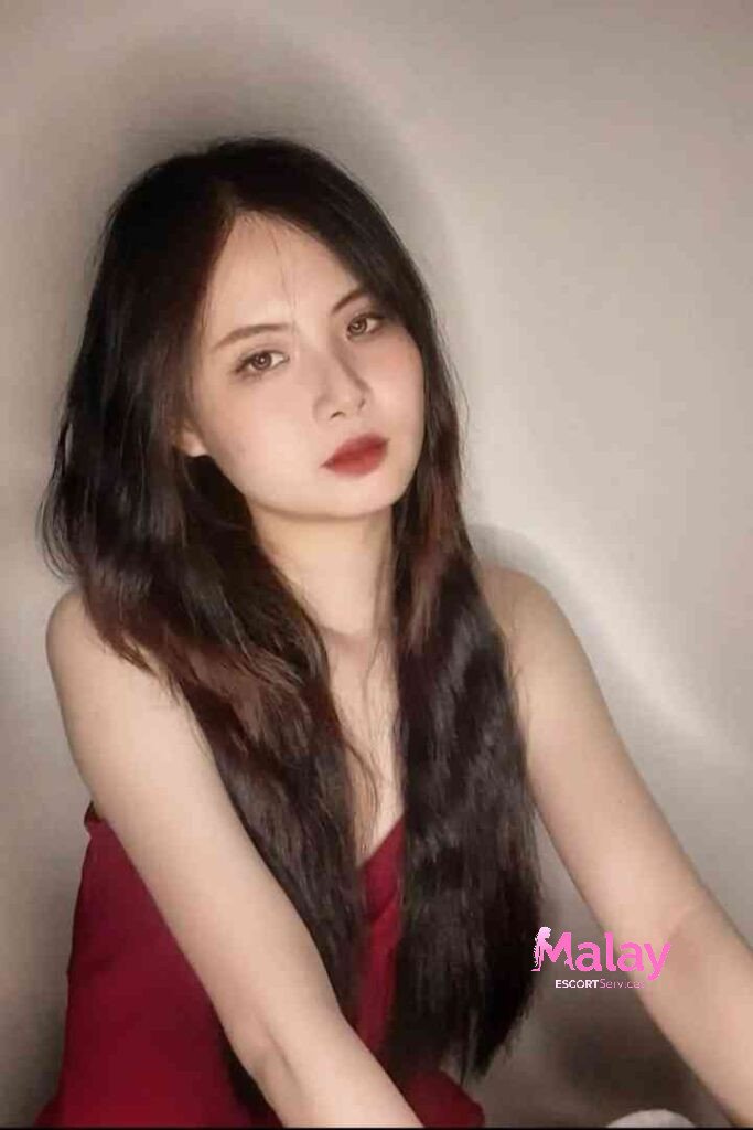 Malay Escort Service Young woman with long dark hair and red lipstick looking at the camera KL Escort Girl Malay Escort KL Real KL Escorts Ready for You Malay Escort Service Young woman with long dark hair and red lipstick looking at the camera KL Escort Girl