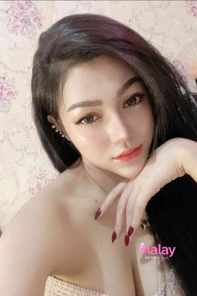 Malay Escort Service Closeup of a woman with long hair wearing a gold dress and red nail polish KL Escort Girl Malay Escort KL Real KL Escorts Ready for You Malay Escort Service Close up of a woman with long hair wearing a gold dress and red nail polish KL Escort Girl