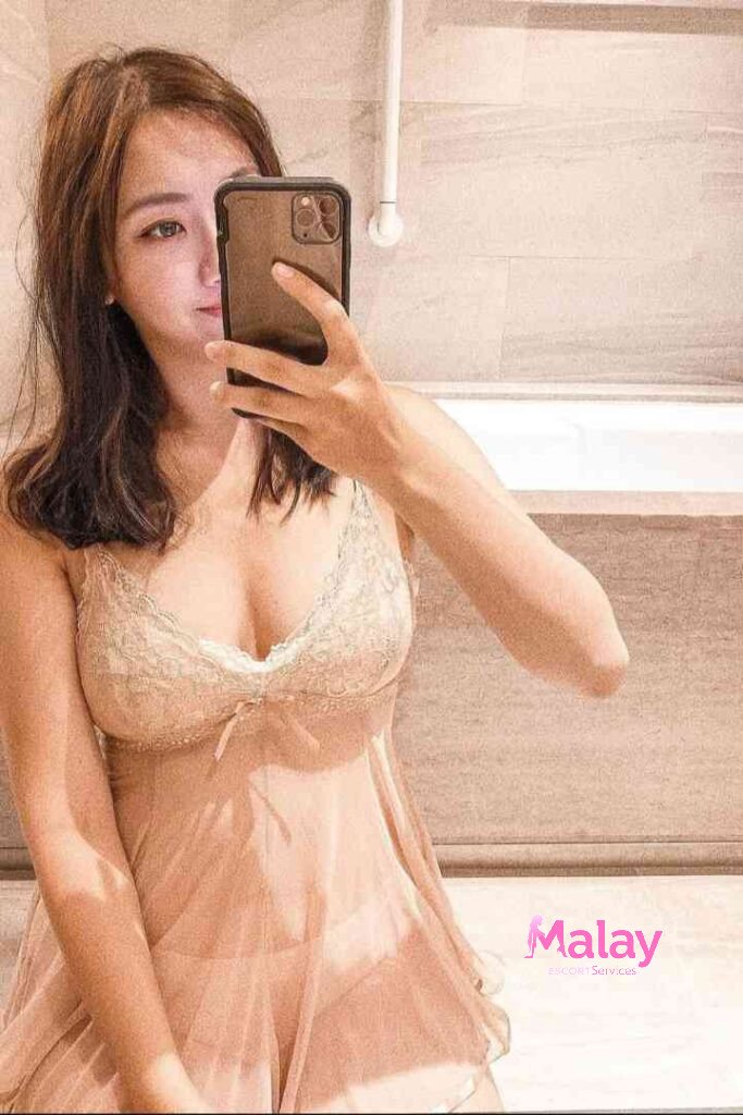 Malay Escort Service Woman in sheer negligee taking a mirror selfie in a bathroom KL Escort Girl Malay Escort KL Real KL Escorts Ready for You Malay Escort Service Woman in sheer negligee taking a mirror selfie in a bathroom KL Escort Girl