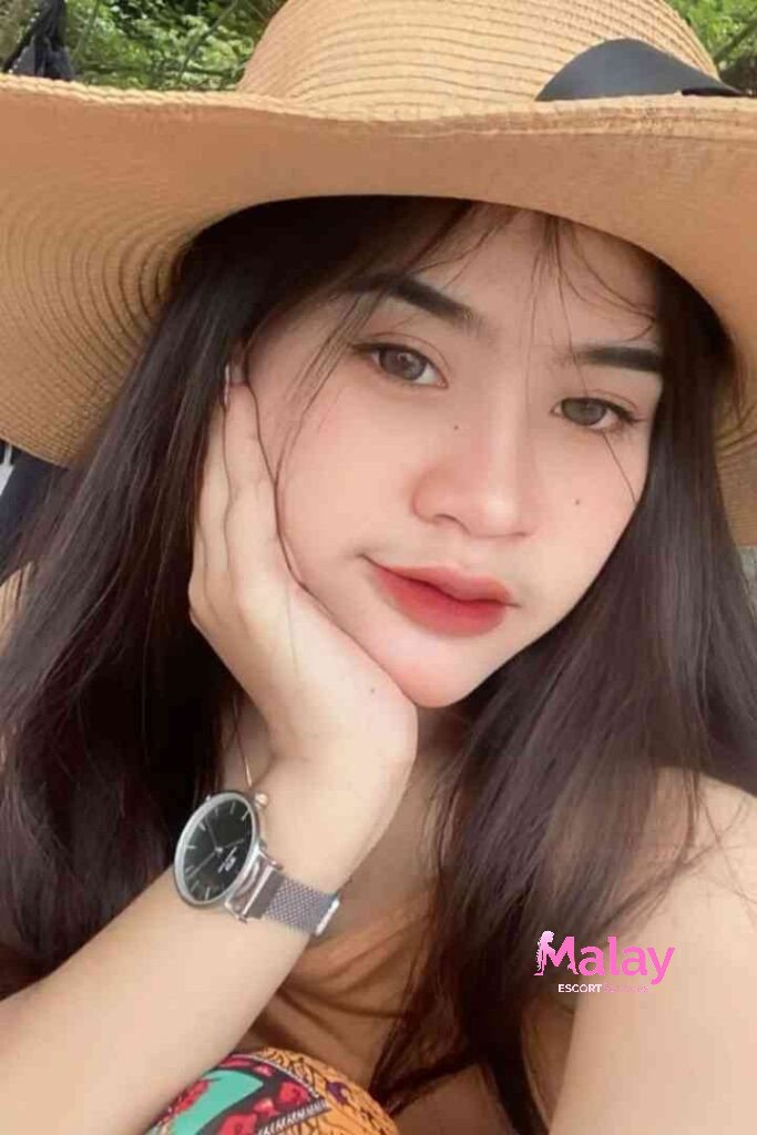 Malay Escort Service Young woman in a straw hat with hand on chin wearing a watch KL Escort Girl Malay Escort KL Real KL Escorts Ready for You Malay Escort Service Young woman in a straw hat with hand on chin wearing a watch KL Escort Girl