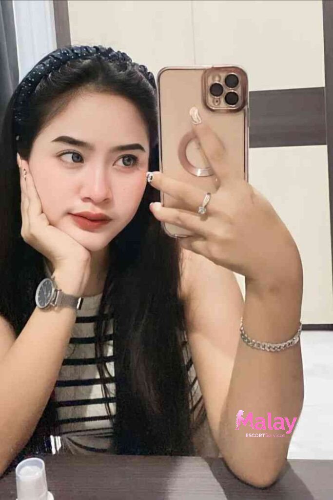 Malay Escort Service Young woman with headband taking a selfie with her phone KL Escort Girl Malay Escort KL Real KL Escorts Ready for You Malay Escort Service Young woman with headband taking a selfie with her phone KL Escort Girl