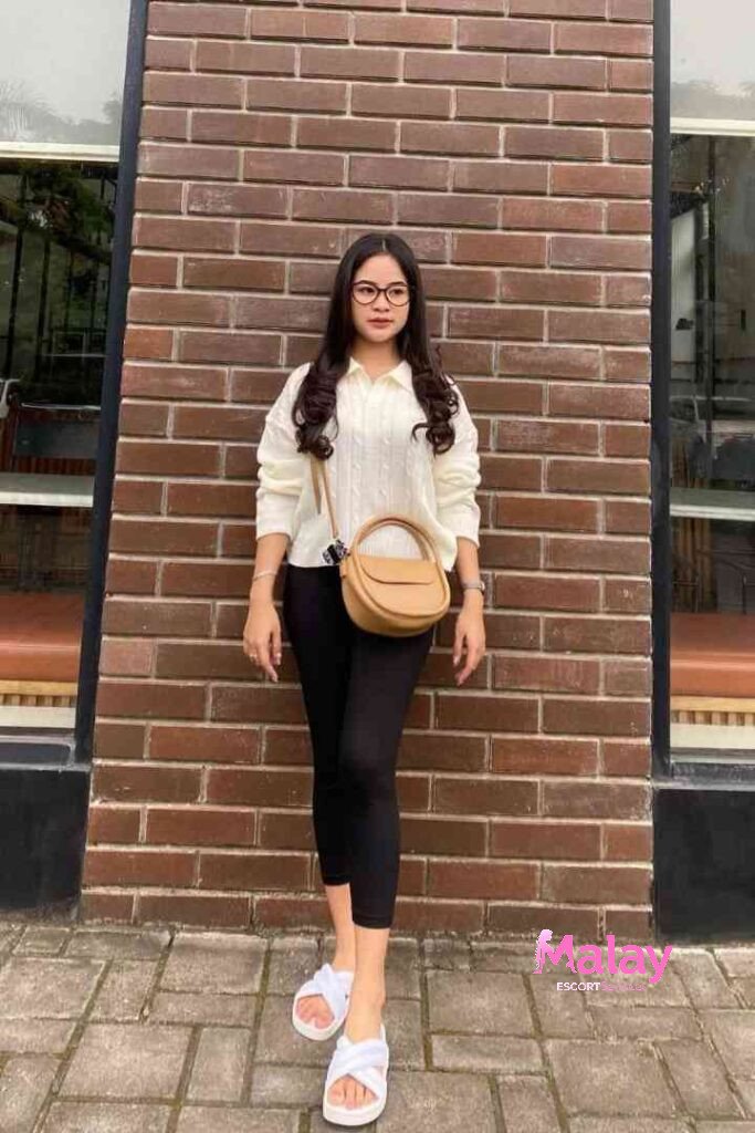 Malay Escort Service Woman in white sweater and black leggings posing against a brick wall KL Escort Girl Malay Escort KL Real KL Escorts Ready for You Malay Escort Service Woman in white sweater and black leggings posing against a brick wall KL Escort Girl