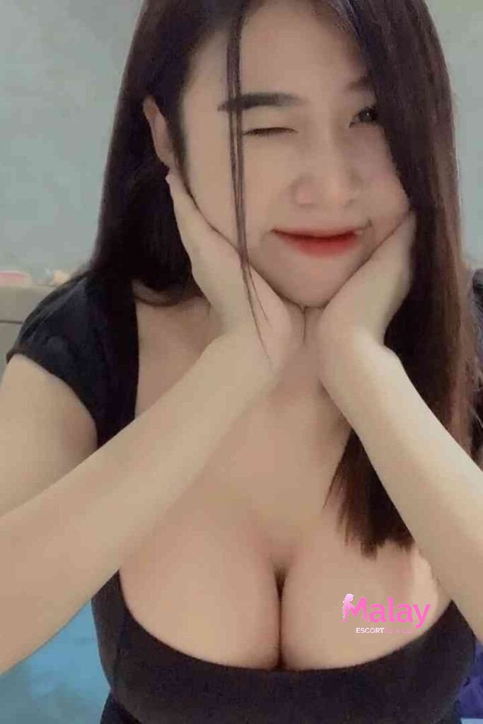 Malay Escort Service Young woman with long dark hair winks with her hands on her cheeks KL Escort Girl Malay Escort KL Real KL Escorts Ready for You Malay Escort Service Young woman with long dark hair winks with her hands on her cheeks KL Escort Girl