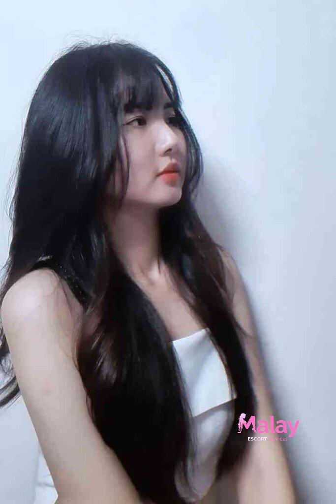 Malay Escort Service Young woman with long black hair and bangs wearing a white top looking to the side KL Escort Girl Malay Escort KL Real KL Escorts Ready for You Malay Escort Service Young woman with long black hair and bangs wearing a white top looking to the side KL Escort Girl