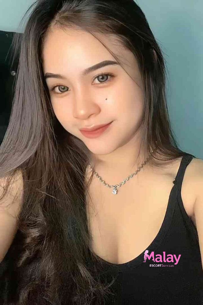 Malay Escort Service Young woman with long dark hair and a black tank top wearing a silver necklace KL Escort Girl Malay Escort KL Real KL Escorts Ready for You Malay Escort Service Young woman with long dark hair and a black tank top wearing a silver necklace KL Escort Girl