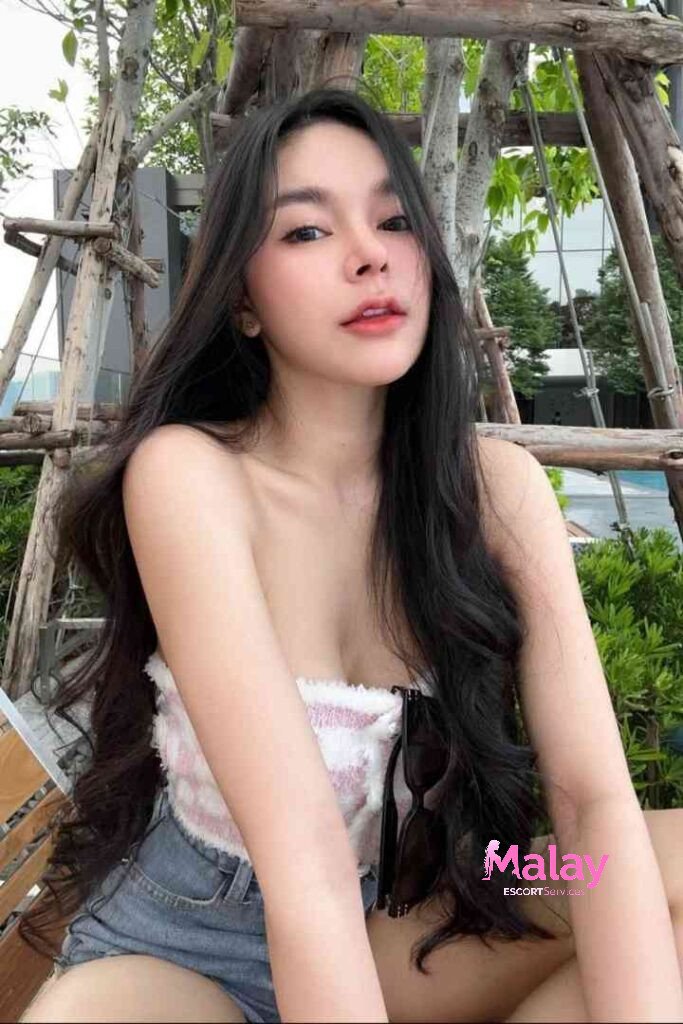 Malay Escort Service Young woman with long dark hair wearing a pink and white tube top and denim shorts outdoors KL Escort Girl Malay Escort KL Real KL Escorts Ready for You Malay Escort Service Young woman with long dark hair wearing a pink and white tube top and denim shorts outdoors KL Escort Girl
