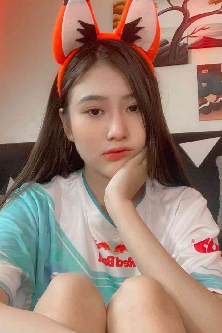 Malay Escort Service Young woman with fox ears headband wearing a t-shirt with red bull logo. KL Escort Girl