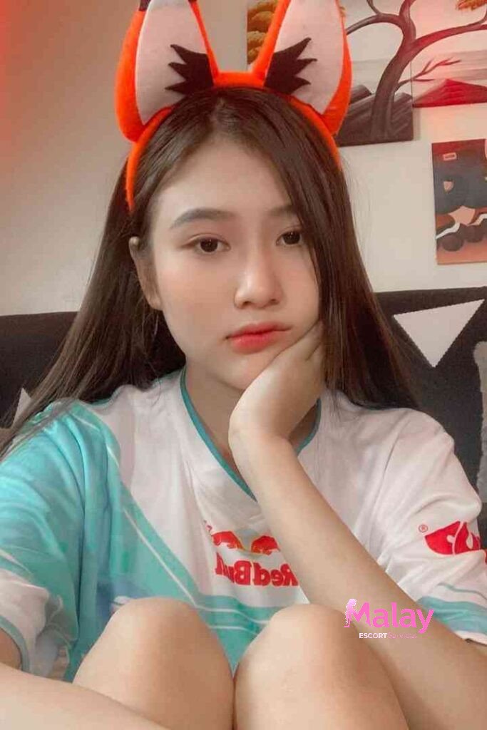 Malay Escort Service Young woman with fox ears headband and tshirt KL Escort Girl Malay Escort KL Real KL Escorts Ready for You Malay Escort Service Young woman with fox ears headband and t shirt KL Escort Girl