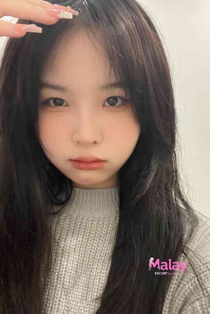 Malay Escort Service Young woman with dark hair and light skin wearing a grey sweater looking at the camera KL Escort Girl Malay Escort KL Real KL Escorts Ready for You Malay Escort Service Young woman with dark hair and light skin wearing a grey sweater looking at the camera KL Escort Girl