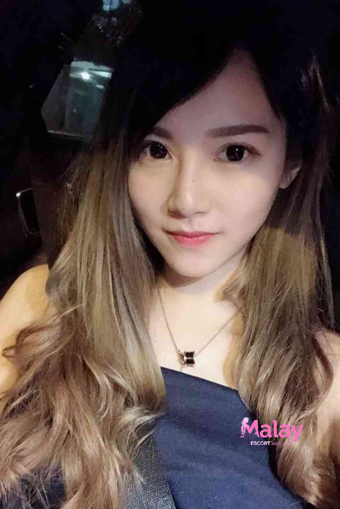 Malay Escort Service Young woman with ombre hair and a black necklace smiles KL Escort Girl