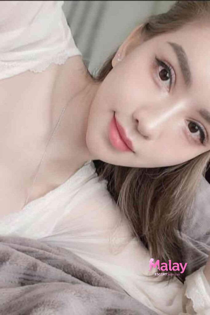 Malay Escort Service Closeup of a young woman with light makeup soft smile and brown hair wearing a white top KL Escort Girl Malay Escort KL Real KL Escorts Ready for You Malay Escort Service Close up of a young woman with light makeup soft smile and brown hair wearing a white top KL Escort Girl