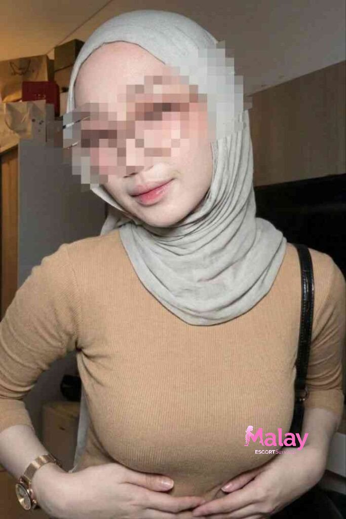 Malay Escort Service Woman in a beige top and grey hijab KL Escort Girl