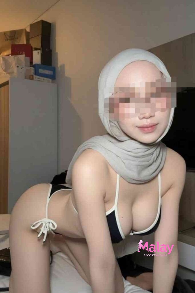 Malay Escort Service Woman in hijab and bikini posing on a bed KL Escort Girl